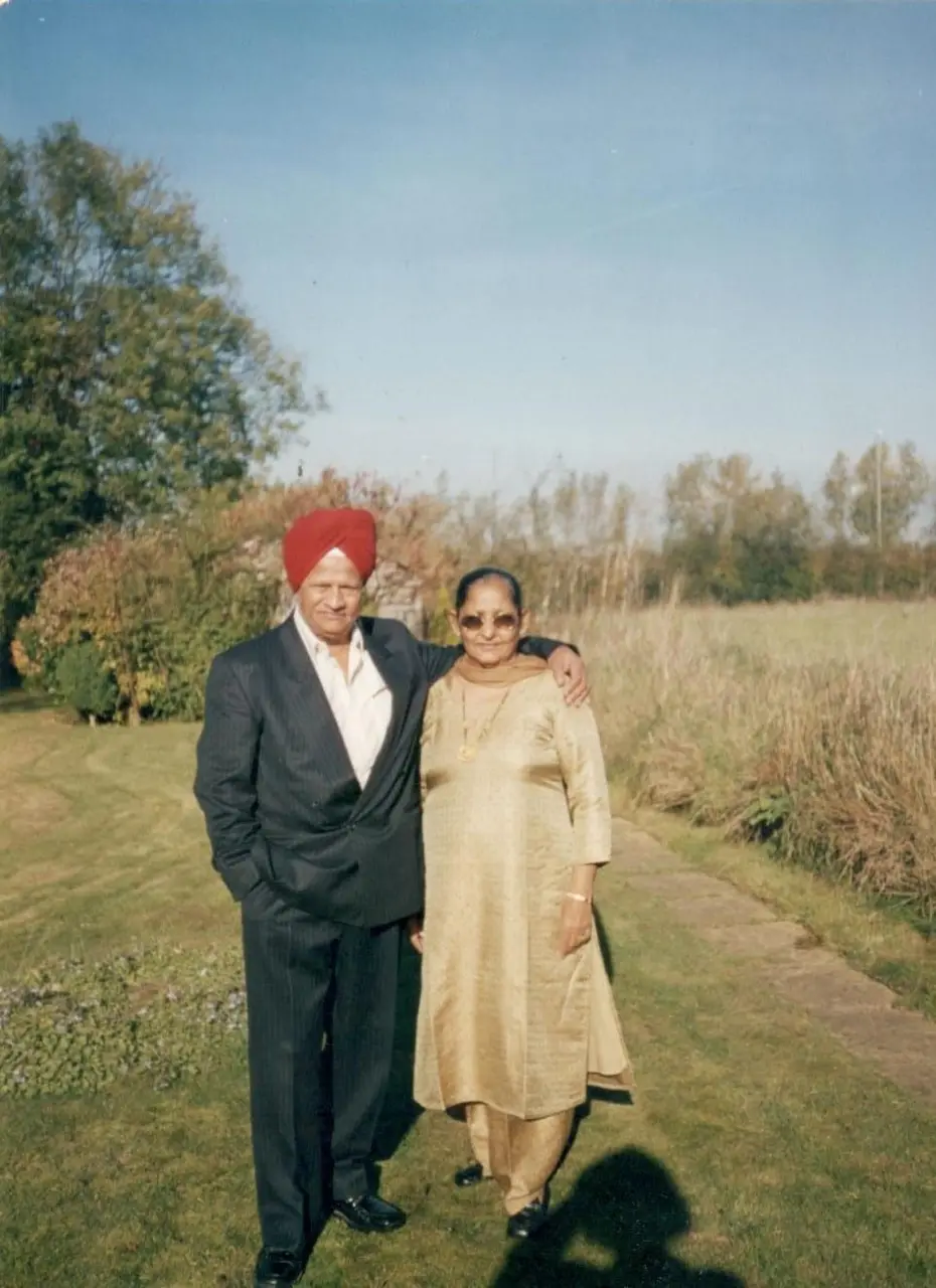 Mummy and Daddy standing in a sunny field