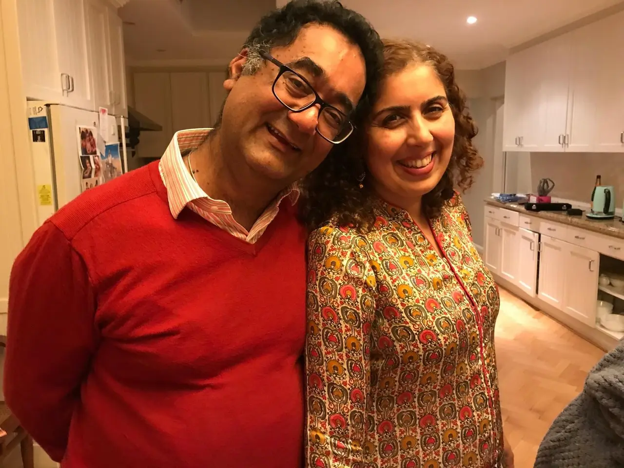 A couple smiling together in a kitchen